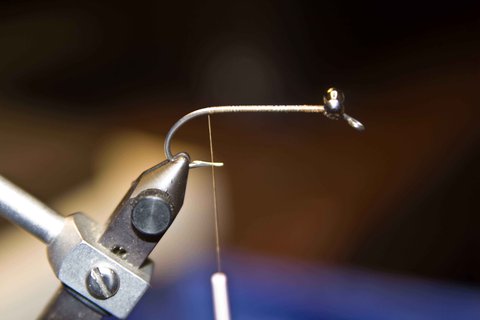 Bend a #2 hook near the eye like a 60 deg. jig hook. Secure lead eyes on top of the hook and take the thread back to the bend.